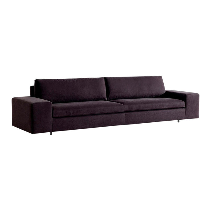 Modern dark purple sofa with a sleek, minimalist design and smooth fabric texture. Perfect for contemporary living spaces.