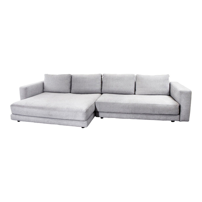 L-shaped sofa in soft light gray fabric with a modern, minimalist design and smooth upholstery.