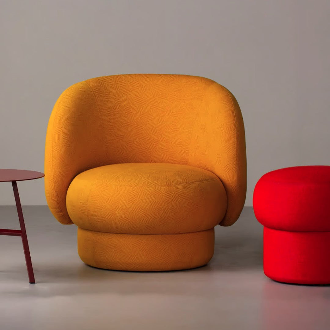 Bold yellow round chair with soft texture next to a bright red ottoman, set against a neutral backdrop. Perfect for modern decor.