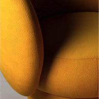 Vibrant yellow upholstered chair with intricate geometric pattern, featuring textured fabric and rounded arms.