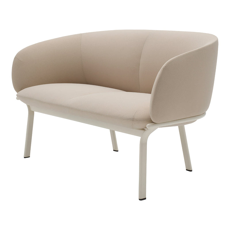 Beige curved loveseat with smooth upholstery and white metal legs, perfect for modern home decor.