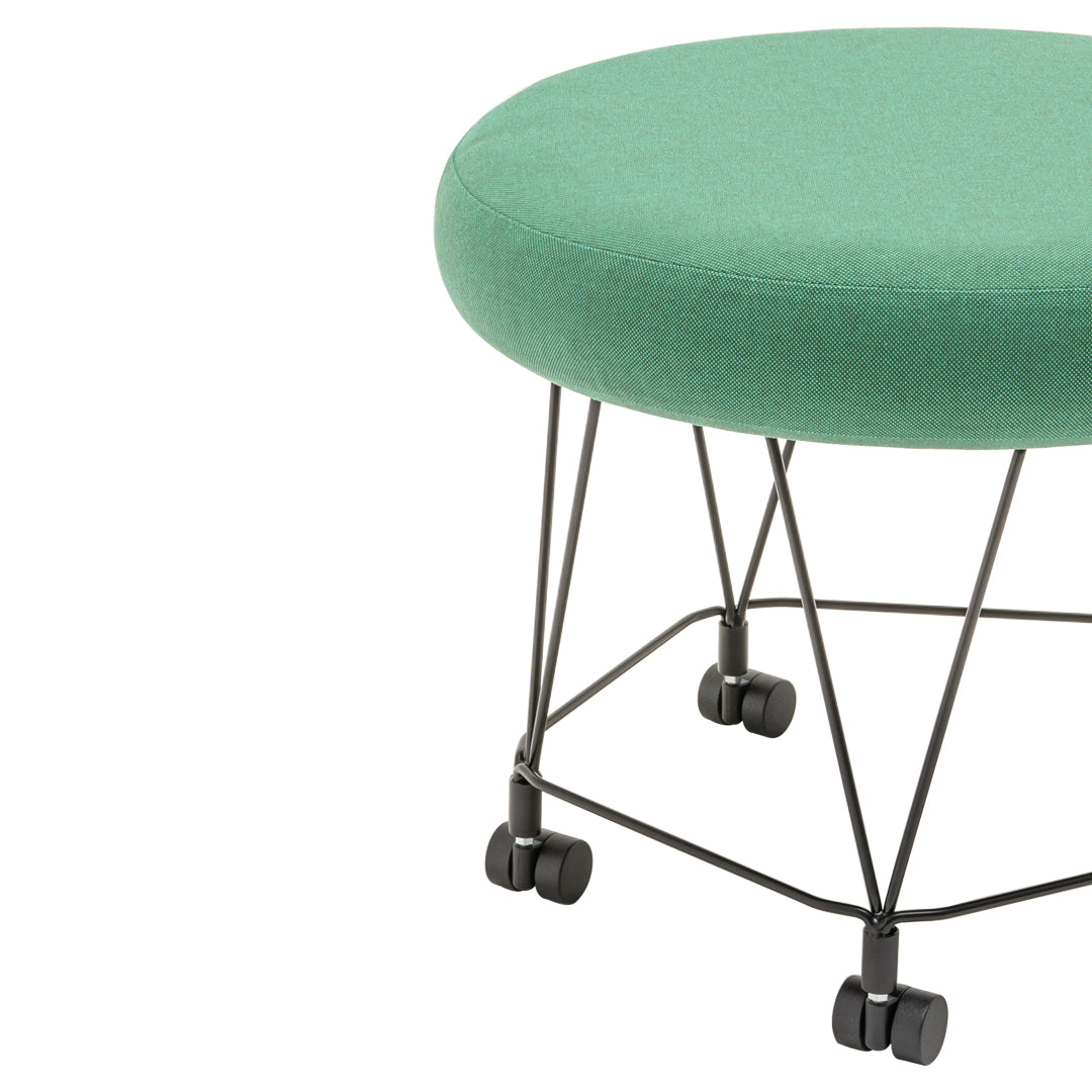 Green upholstered round ottoman with a chic black wire frame and wheels for easy mobility.