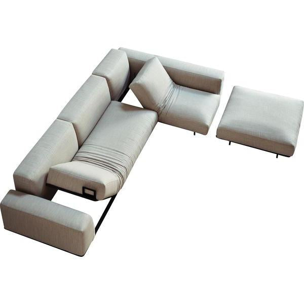 Light gray sectional sofa with a minimalist design and subtle texture, featuring a matching ottoman.