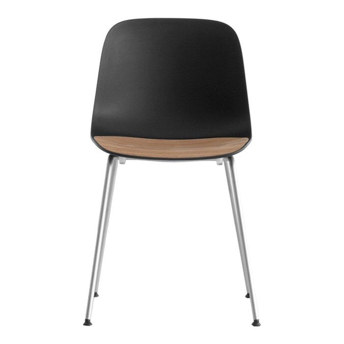 Black chair with a wood accent and chrome legs, featuring a sleek, minimalist design suitable for modern decor.