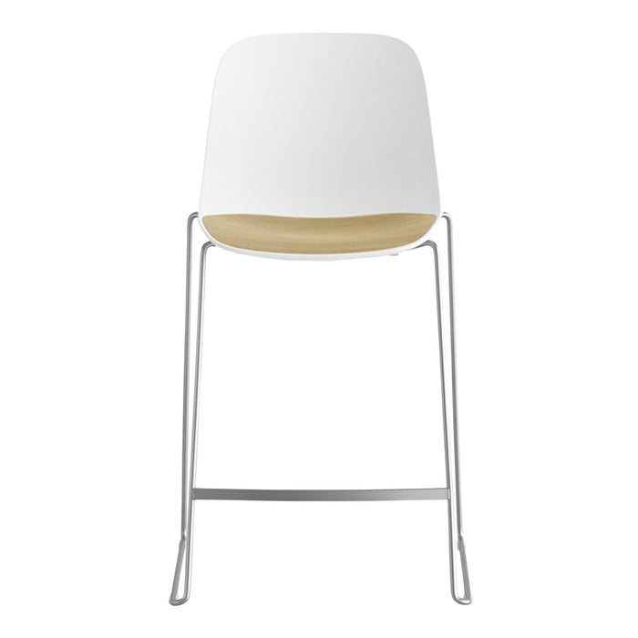 White and natural wood bar stool with a sleek chrome frame, minimalist design and smooth surface.