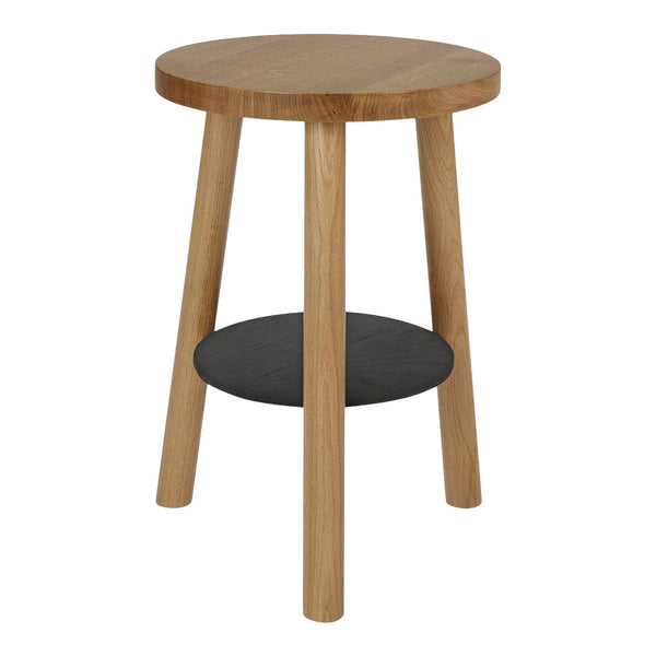 Natural wood round side table with light oak finish and a contrasting black shelf beneath.