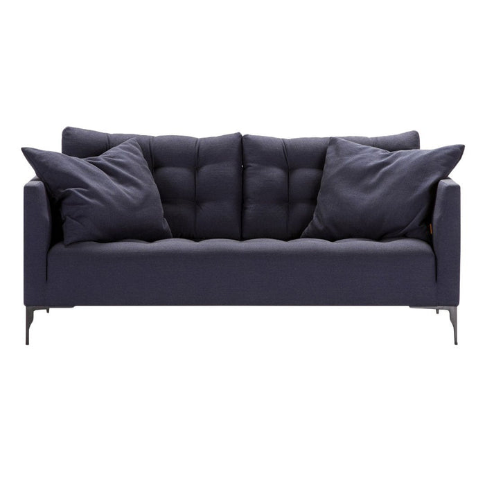 Navy blue tufted sofa with matching cushions, featuring a sleek modern design and subtle texture.