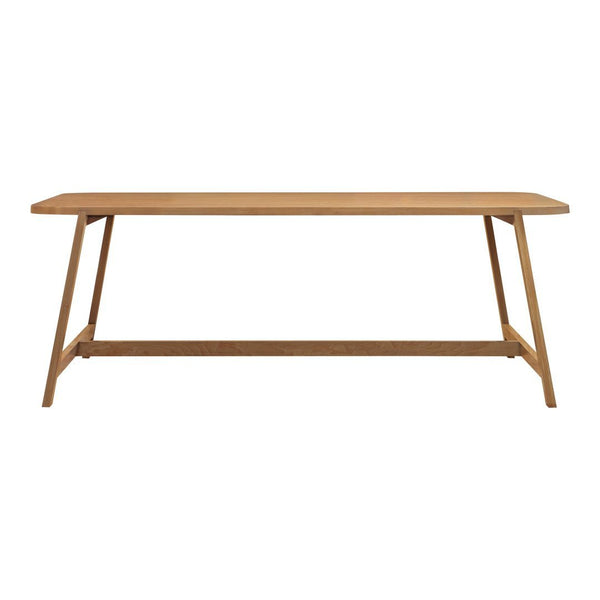Light oak wood dining table with a smooth, plain surface and angled legs, showcasing natural wood grain patterns.