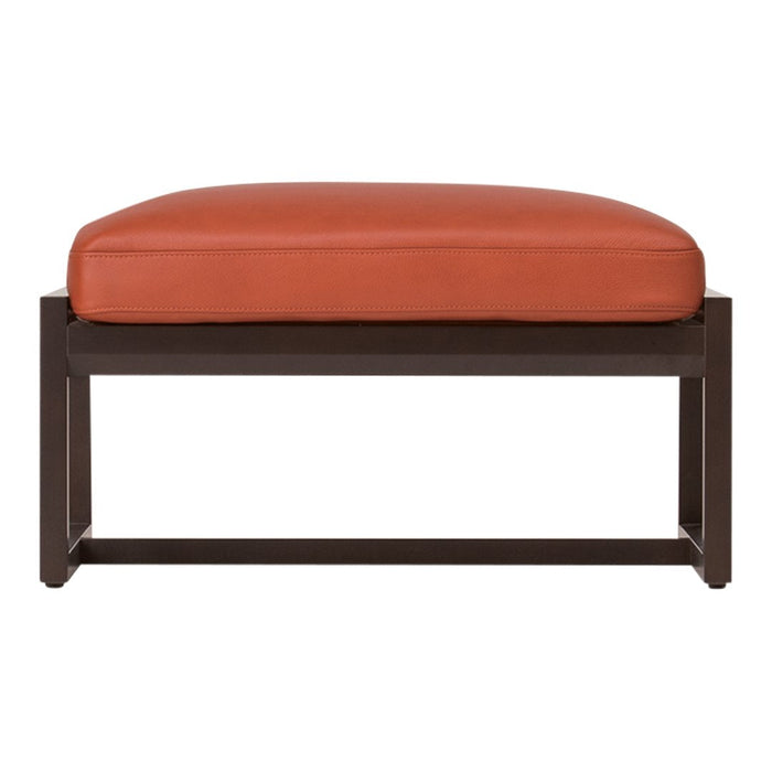 Rust-orange cushion atop a sleek dark metal frame, showcasing a modern, minimalist design.