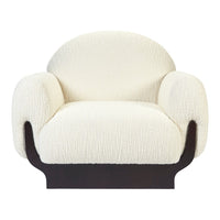 Cream textured upholstery on a rounded armchair with a sleek black base. Perfect for modern decor.
