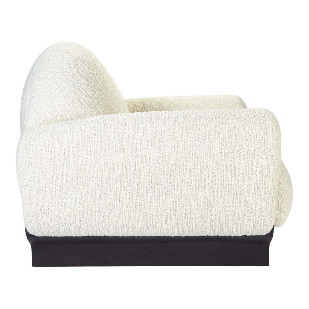 "Textured cream upholstery sofa with a sleek black base, featuring subtle ribbed patterns for modern elegance."