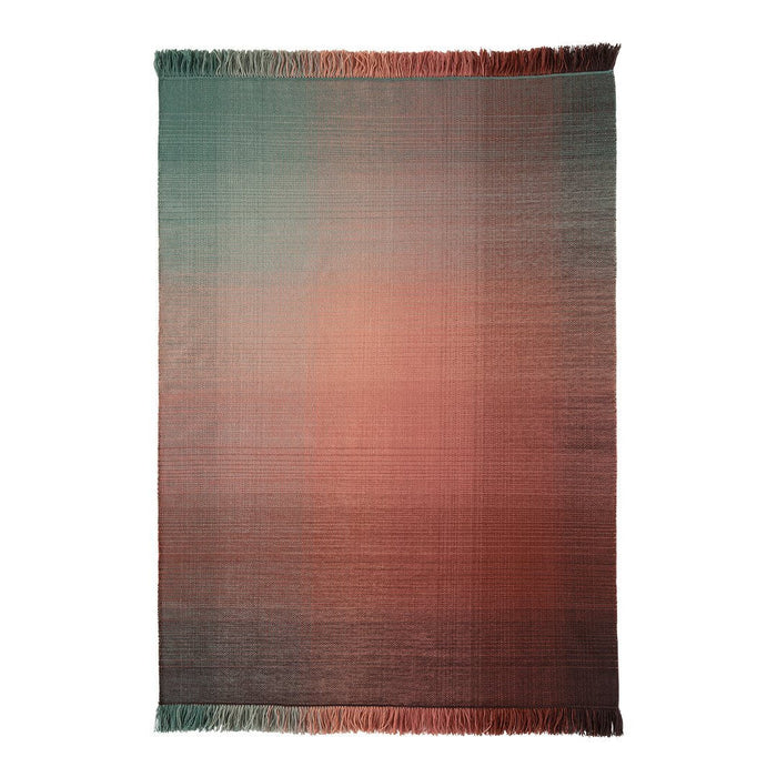 Gradient rug featuring a blend of teal, coral, and soft neutrals with fringe edges for a modern touch.