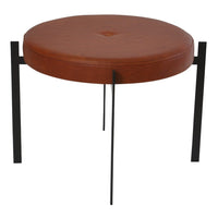 "Round brown leather stool with button detail and sleek black metal legs."