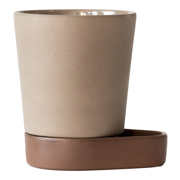 Beige ceramic planter with a glossy finish and a brown drainage tray. Simple, modern design.