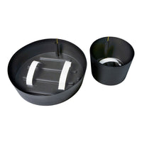 Black round and cylindrical planters with white accents and a smooth matte finish. Perfect for modern decor.