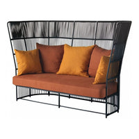 Modern black frame sofa with orange cushions, featuring a sleek woven pattern and stylish high back design.