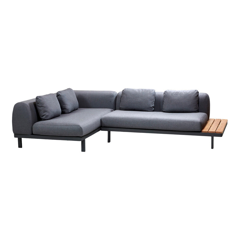 Gray sectional sofa with smooth fabric and wood accent table, featuring modern lines and minimalist design.