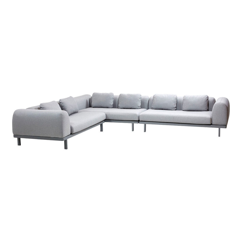 Modern grey sectional sofa with minimalistic design and plush cushions, featuring a sleek metal frame.
