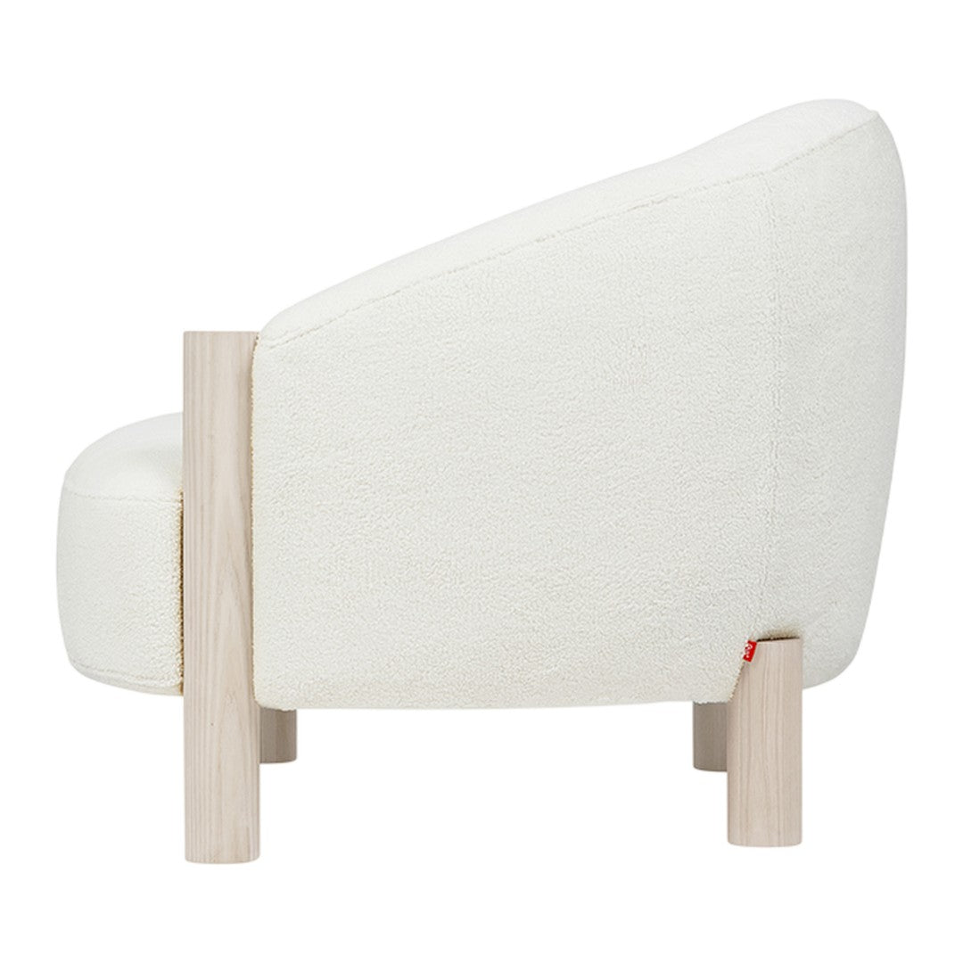 Cozy white upholstered chair with soft texture and light wood legs, perfect for modern interiors.