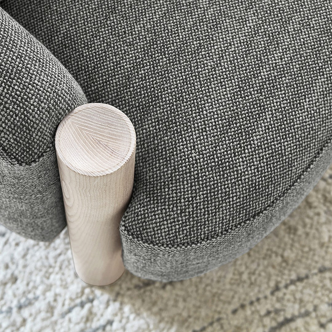 Gray textured fabric with subtle pattern on a rounded chair, featuring a light wood leg for contrast.