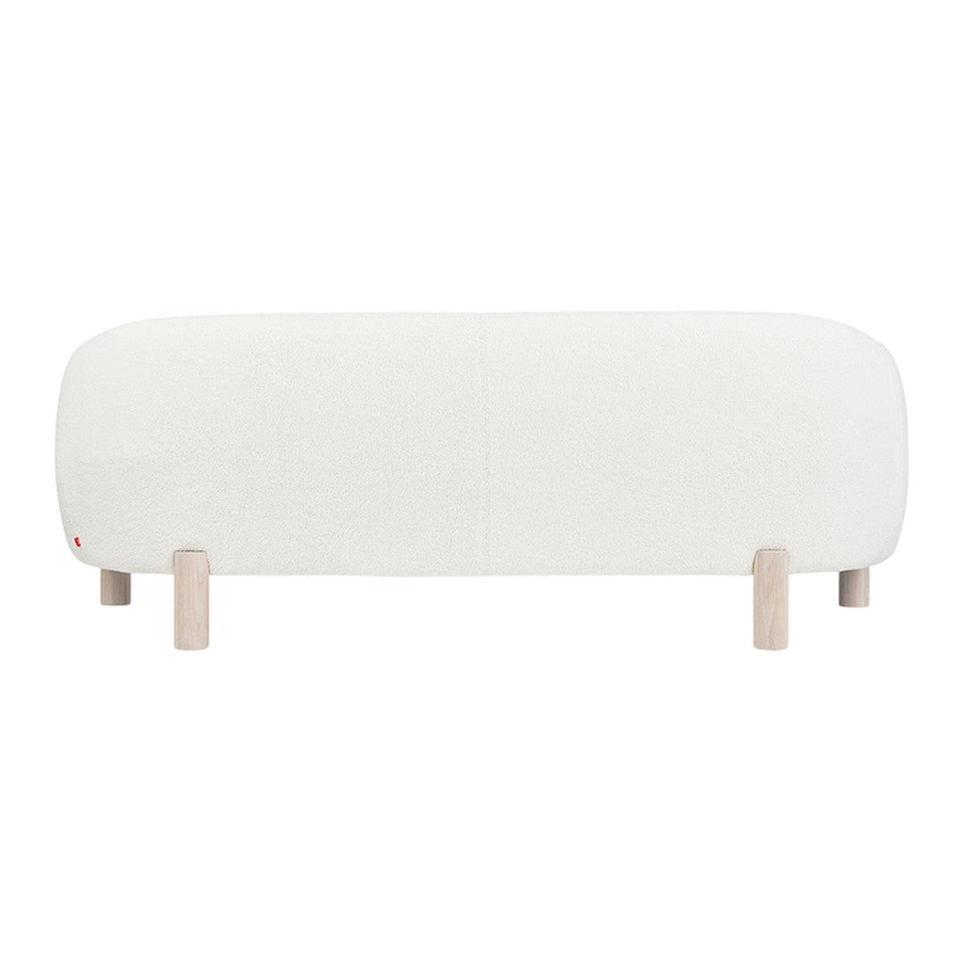 Minimalist white sofa with soft, rounded edges and light wooden legs for a contemporary look.