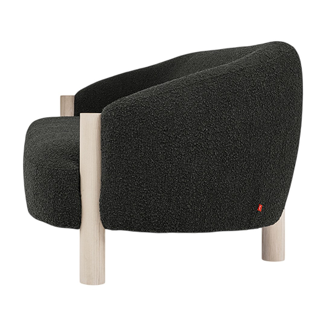 Cozy dark gray upholstered chair with a textured fabric and light wooden legs, featuring a subtle red accent.