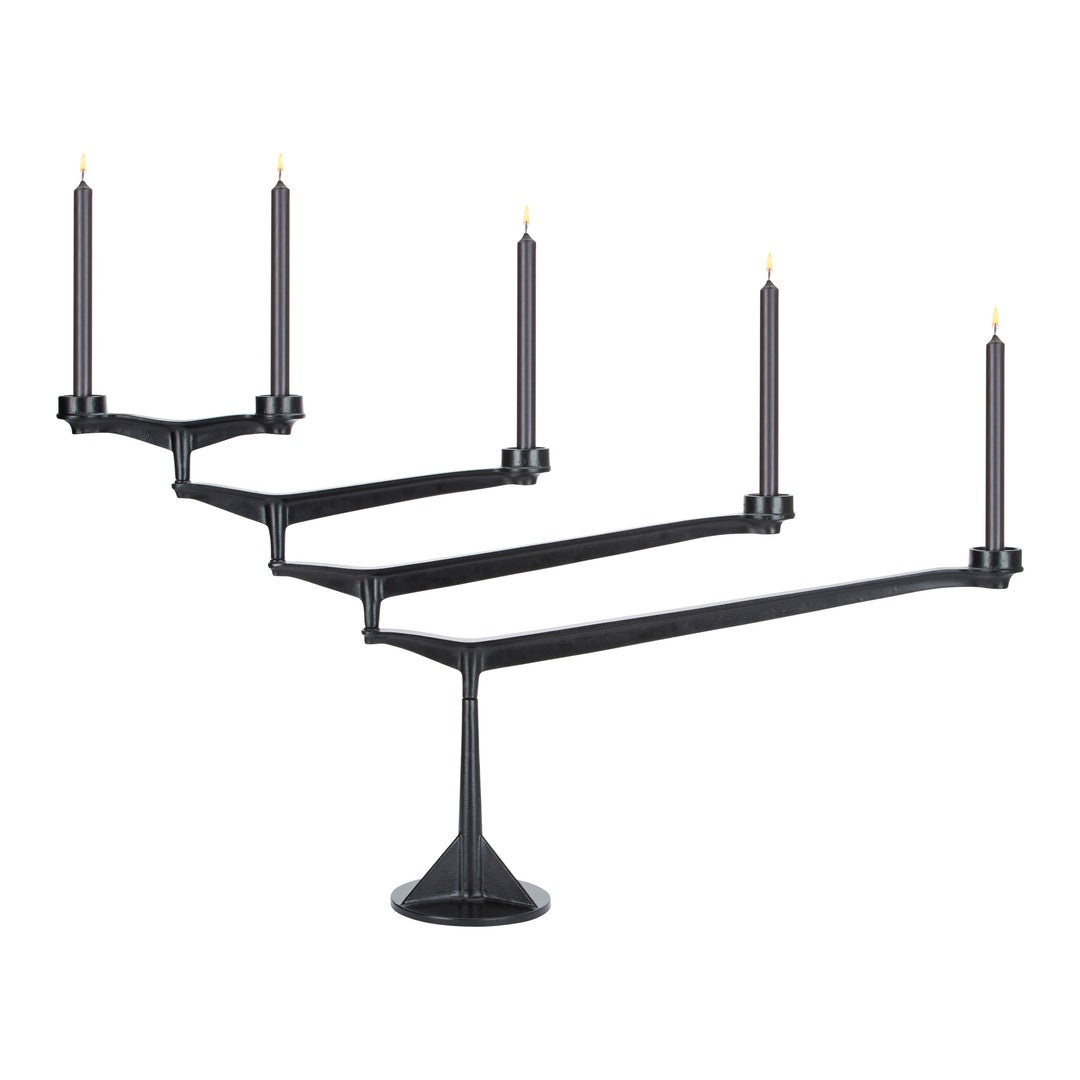 Sleek black candle holder with five arms, featuring a minimalist design and contrasting gold candle tips.