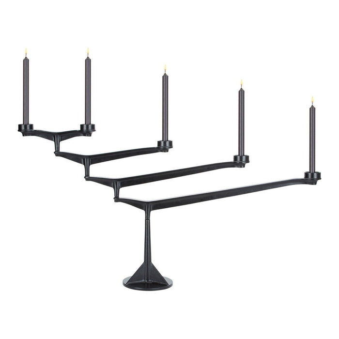 Sleek black candle holder with five arms, featuring a minimalist design and contrasting gold candle tips.
