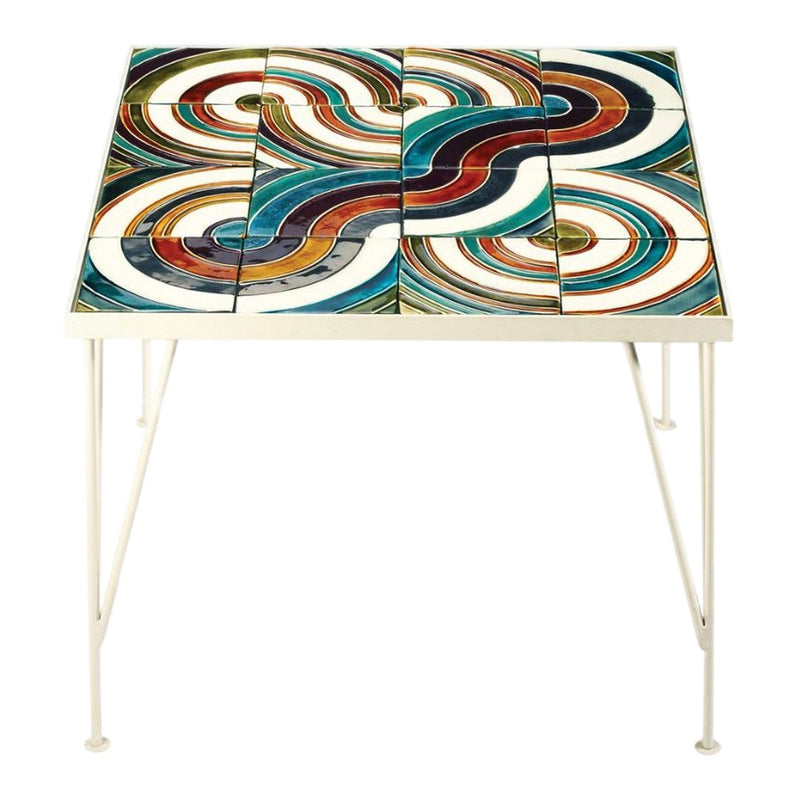 Colorful patterned table featuring swirling blue, red, and white designs on a glossy surface. White metal legs.