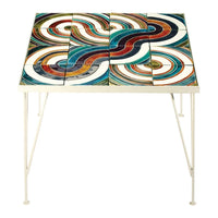 Colorful wave-patterned table with teal, orange, red, and white tiles against a sleek white metal frame.