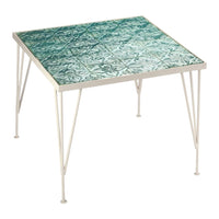 Square table featuring a turquoise patterned tile top and sleek white metal legs.