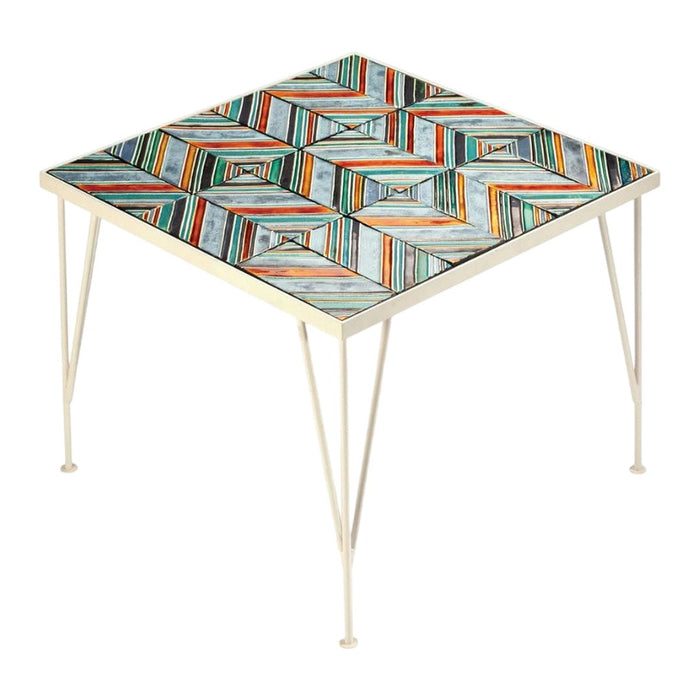 Square table with colorful geometric pattern in orange, blue, and cream. Ideal for vibrant decor.