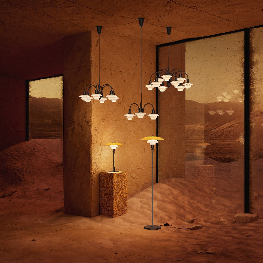 Modern lighting featuring warm tones, black accents, and elegant floral glass patterns in a desert-themed setting.
