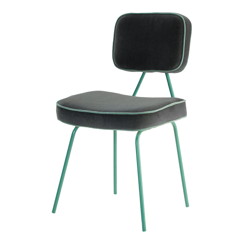 Stylish black chair with green metal legs and matching piping. Modern design perfect for any decor.