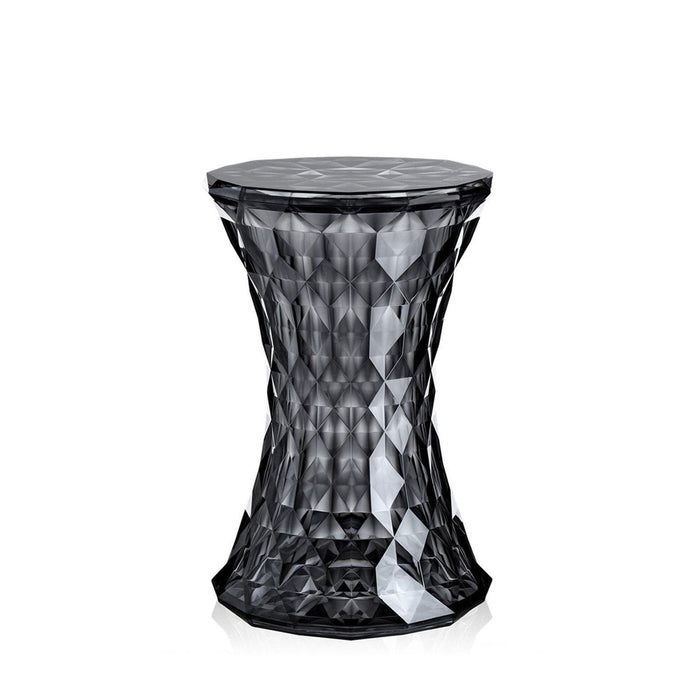 Black faceted stool with geometric patterns and a glossy finish, perfect for modern decor.