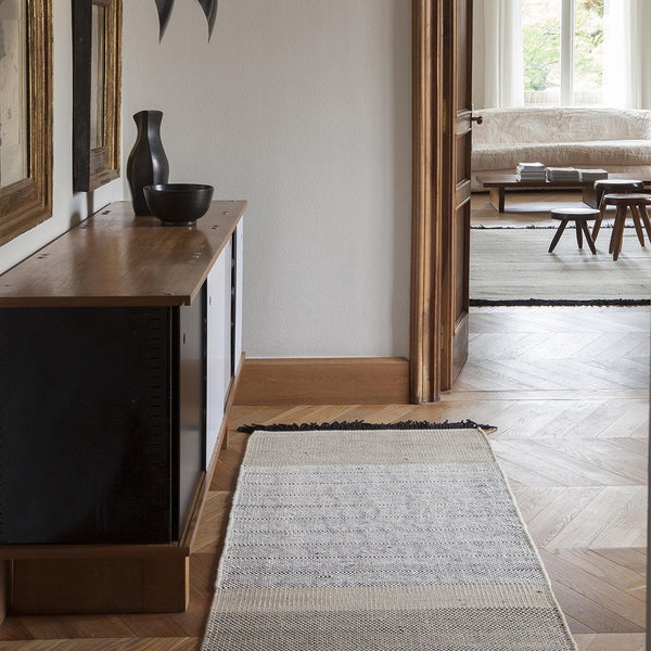Neutral-toned runner rug featuring subtle blue and gray stripes, enhancing modern home decor. Perfect for elegant interiors.