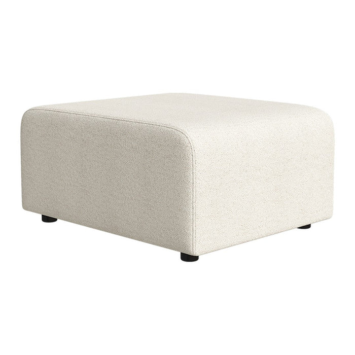 Neutral cream ottoman with a soft texture and rounded corners, perfect for any modern decor.