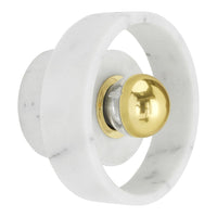 Elegant white marble with subtle gray veining, featuring a shiny gold accent in a circular design. Perfect for modern decor.