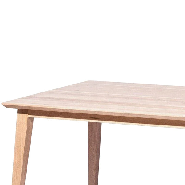 Minimalist light wooden table with a natural finish and clean lines, featuring a smooth, pale surface.