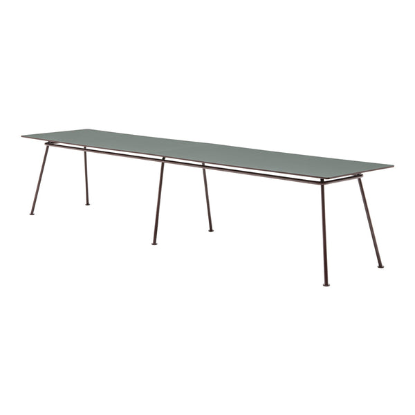 Long rectangular tabletop in muted green with sleek metal legs, featuring a minimalist design and no visible patterns.