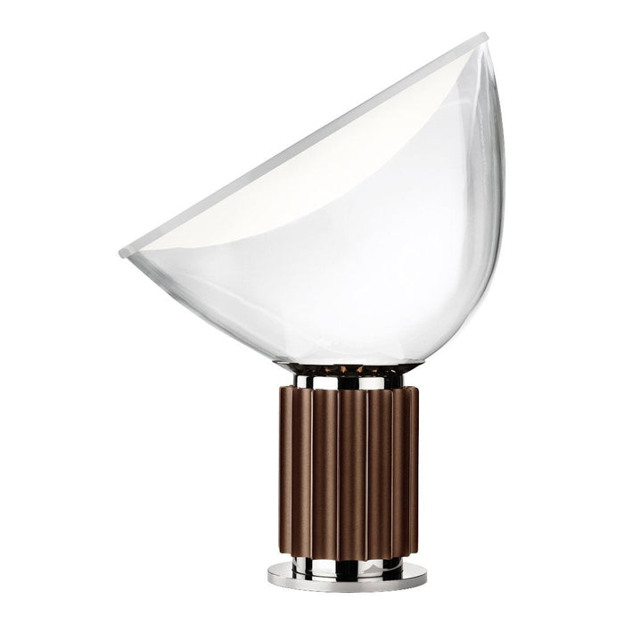 Modern table lamp with a clear glass shade and a rich brown ribbed base. Sleek chrome accents enhance its contemporary design.