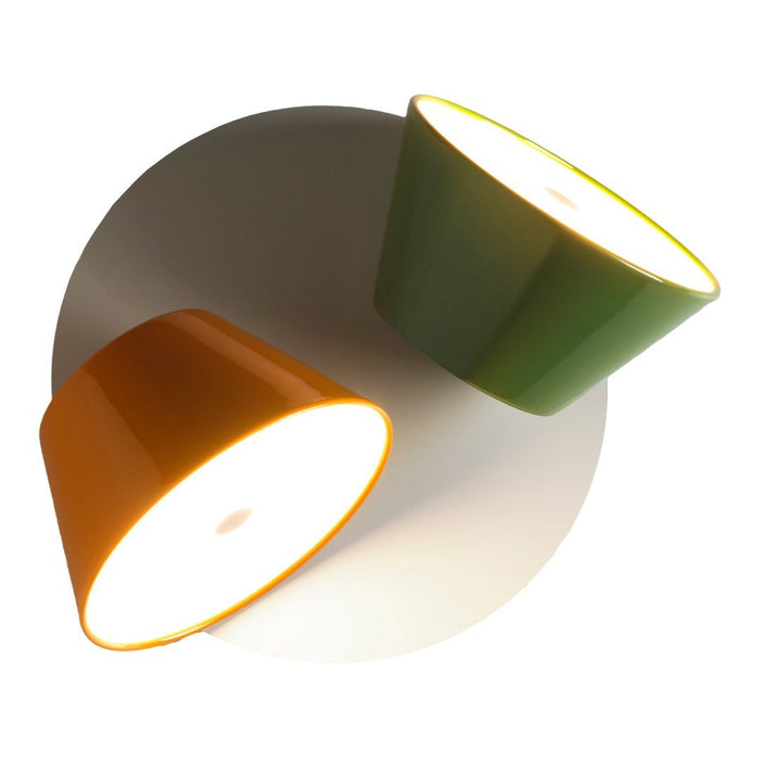 "Colorful modern lamps featuring orange and green cone shapes against a white circular background."