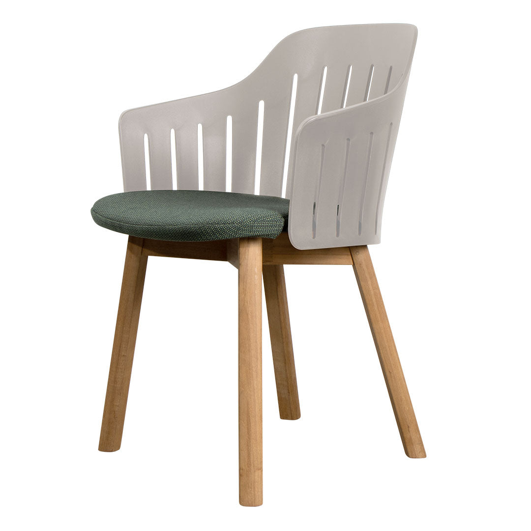 Gray and white chair with a green cushion and natural wood legs. Modern design with a slatted backrest pattern.