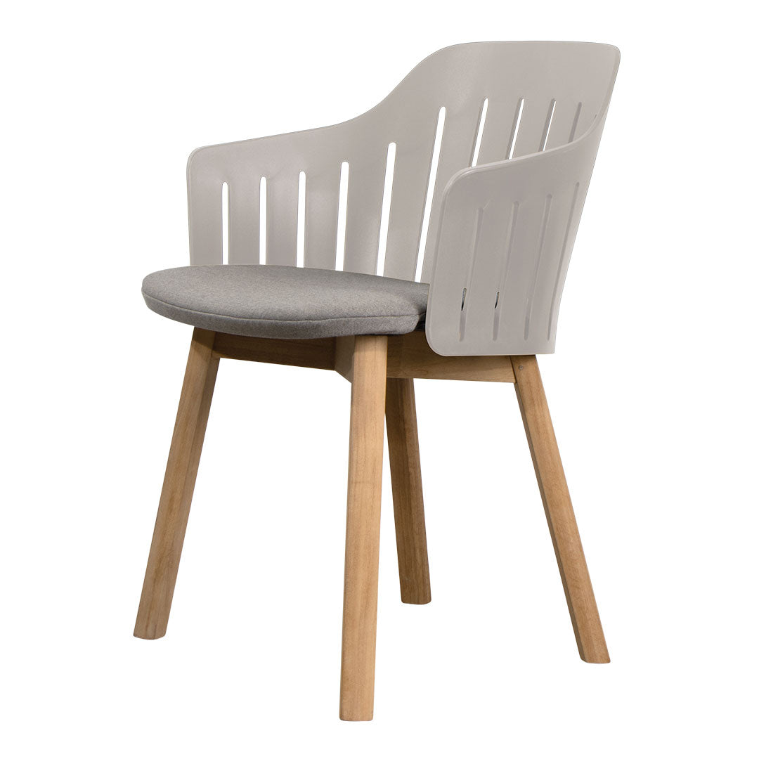 Stylish armchair featuring a grey cushioned seat and minimalist white slatted backrest with natural wood legs.