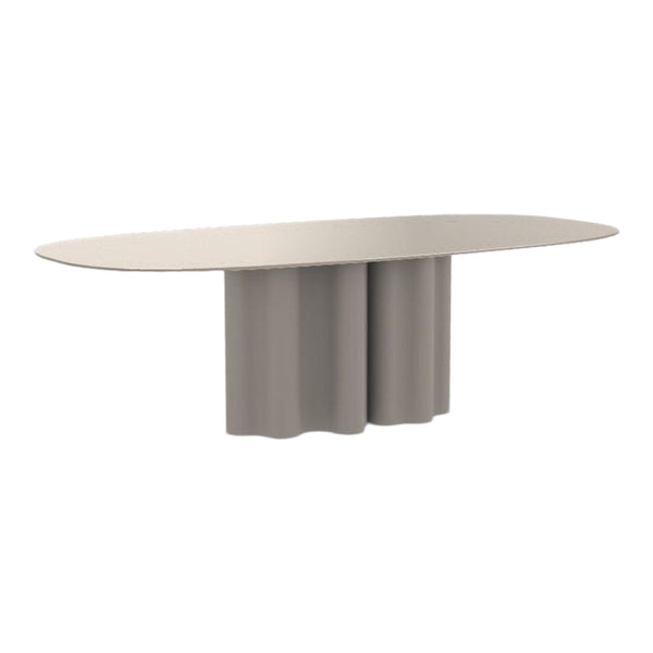 Oval table in soft beige with a rounded, sculptural base and seamless finish. Modern, minimalist design.