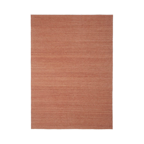 Rust-colored woven rug with a subtle linear pattern for a warm, textured look in any space.