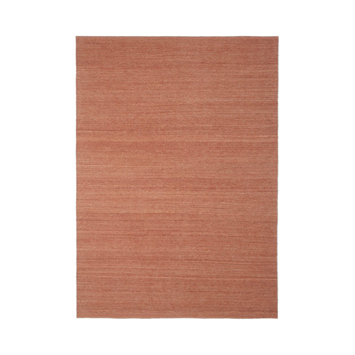 Rust-colored woven rug with a subtle linear pattern for a warm, textured look in any space.