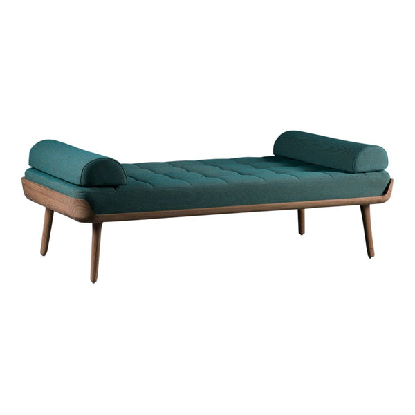 Teal upholstered daybed with a tufted design and wooden legs, featuring two round bolsters on each end.
