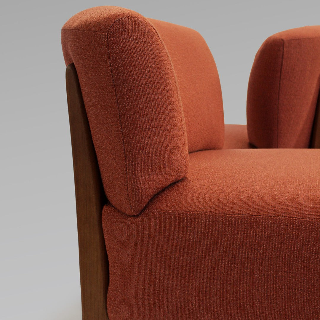 "Textured rust-orange upholstery with smooth wooden accents, perfect for modern decor."