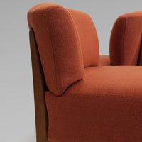 "Textured rust-orange upholstery with smooth wooden accents, perfect for modern decor."